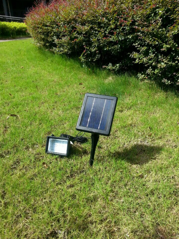 Integrated solar flood light with light controlled