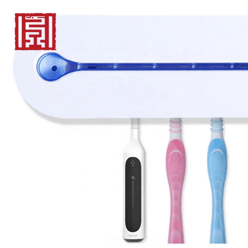 Wall mount bathroom battery operated toothbrush with toothpaste tube squeezer dispenser